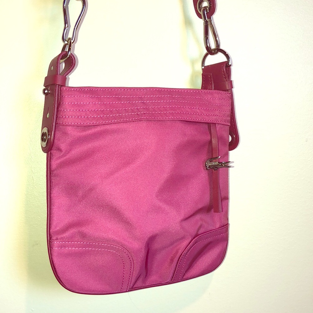 Dark pink Lacoste crossbody bag.